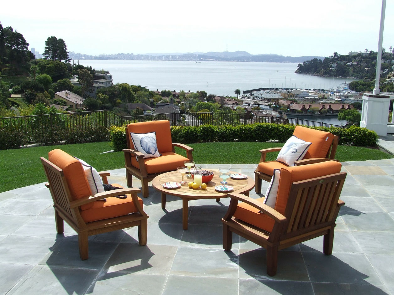Image: Cement patio with orange furnishings.